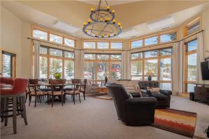 a living room with a table and chairs and a chandelier at RMR: Cody House B Condo in Teton Village in Teton Village