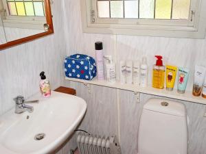 a bathroom with a sink and a toilet and a mirror at 6 person holiday home in Löderup in Löderup +11 photos