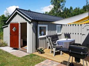 a small shed with a table and a grill at 6 person holiday home in Löderup in Löderup