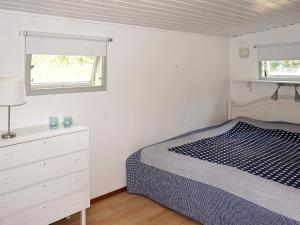 a bedroom with a bed and a dresser and a window at 6 person holiday home in Löderup in Löderup