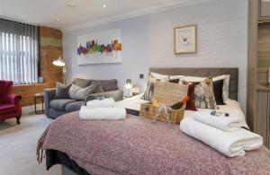a bedroom with a large bed with towels on it at 58 Cocoa Suites Riverside Studio with Parking in York