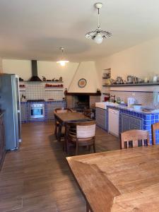 a kitchen with blue cabinets and a table and chairs at Villa Silvana Quiet Escape in Bolsena