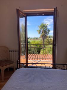 a bedroom with a bed and a sliding glass door at Villa Silvana Quiet Escape in Bolsena