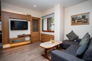 a living room with a couch and a tv at Hotel Marcopolo in Kathmandu