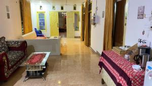 a room with yellow doors and a couch and a table at 88HappyHomestay in Luwuk +22 photos