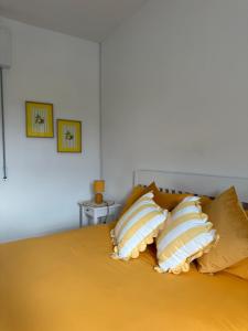 a bed with four pillows on top of it at B&B Il Balcone Fiorito in Imola +37 photos