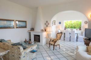 a living room with a couch and a fireplace at Villa La Capperina in Capri