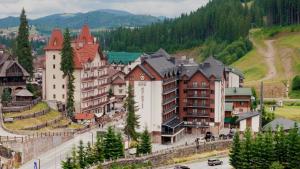 a town in the mountains with a road and buildings at Marmaros Apart-Hotel & Spa in Bukovel