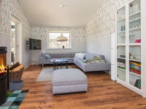 a living room with a couch and a table at 5 star holiday home in Silkeborg in Silkeborg +29 photos