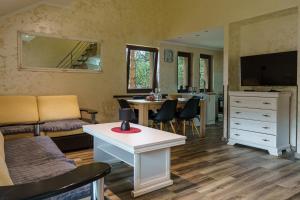 a living room with a white table and a dining room at Apartmani Nevena Divčibare in Divčibare