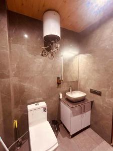 a bathroom with a sink and a toilet at The Edge Retreat A Premium Property in Mussoorie