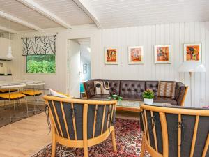 a living room with a couch and a table at 5 person holiday home in Ry in Ry +16 photos