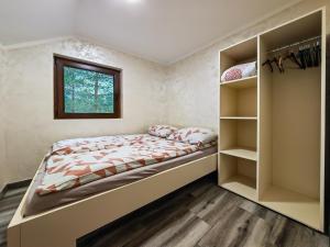 a bedroom with a large bed and shelves at Apartmani Nevena Divčibare in Divčibare