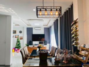 a living room with a dining table and a christmas tree at Cher Cher Pool Villa in Ban Chang