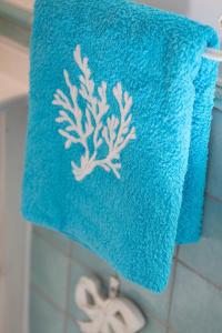 a blue towel with a sea creature on it at Villa La Capperina in Capri