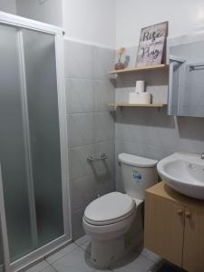 a bathroom with a shower and a toilet and a sink at Casa Mira Towers Guadalupe Condo in Cebu City