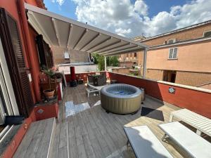 a patio with a hot tub on a building at Terrace of Love in Rome