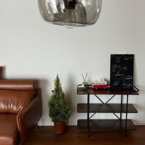 a table with a christmas tree on it next to a couch at snownuts 雪仁儿 in Hakuba