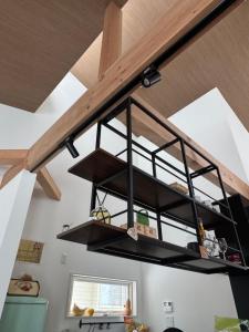 a kitchen with a shelf hanging from the ceiling at snownuts 雪仁儿 in Hakuba