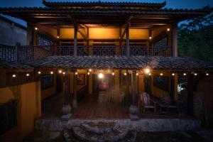 a house with a porch with lights on it at Khói Bản Homestay in Dồng Văn