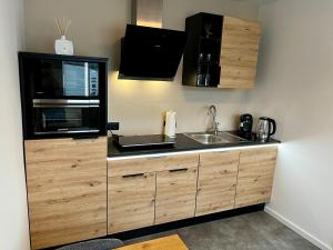 a kitchen with a sink and a microwave at Juwel 02 in Trieben +9 photos