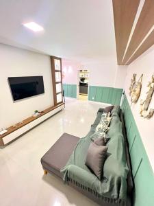 een woonkamer met een bank met kussens erop bij Paraiso dos Anjos in Arraial do Cabo