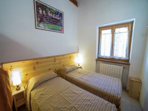 a bedroom with two beds and a window at Apartment in Antey-Saint-André near Ski Area in Antey-Saint-André