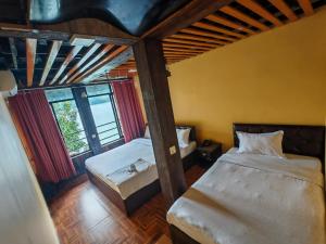 a bedroom with two beds in a room at Cliff lake hotel cafe and bar in Pokhara