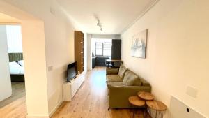 a living room with a couch and a tv at Apartament Modern Urban Space - FREE Parking in Voluntari