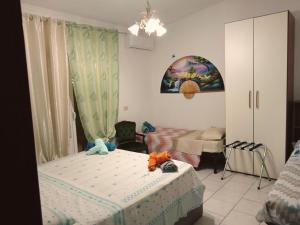 a bedroom with two twin beds and a room with at Nomentum House in Mentana