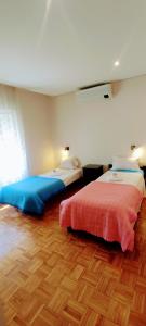 a bedroom with two beds and a wooden floor at Casa de Férias Privada in Amares +47 photos