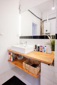 a bathroom with a white sink and a counter at The City Gem in Bratislava +41 photos