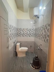 a bathroom with a toilet and a sink at Vainavi Residency in Tirupati +31 photos