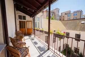 a balcony with chairs and a view of a building at The City Gem in Bratislava