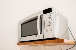 a microwave oven sitting on top of a shelf at The City Gem in Bratislava