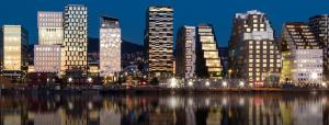a city skyline at night with lights on the water at Frognerstranda - Majestic- in Oslo