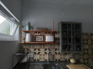 a kitchen with a sink and a counter top at Casa da Avó Caia in Ferreira do Alentejo