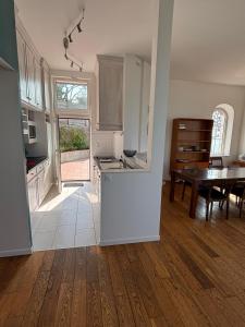 a kitchen and dining room with a table and a kitchen at Villa Waterfront View Chausey in Granville