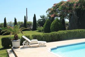 a patio with two chairs and a swimming pool at Villa Diana Mini in Karolino-Buhaz