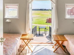 a bedroom with two beds and a balcony with a view at 6 person holiday home in Hadsund in Hadsund