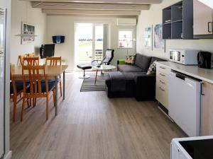 a living room and kitchen with a couch and a table at 6 person holiday home in Hadsund in Hadsund
