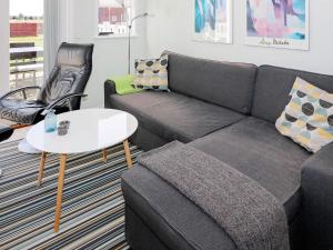 a living room with a couch and a table at 6 person holiday home in Hadsund in Hadsund