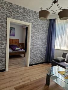 a living room with a brick wall at Pension Haus Sonneck in Wildemann
