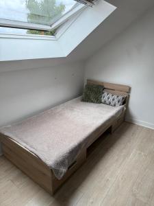 a bed in the corner of a room with a window at Maison aux portes de la Sologne in Marcilly-en-Villette