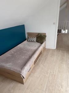 a large bed in a room with a wooden floor at Maison aux portes de la Sologne in Marcilly-en-Villette +1 photo