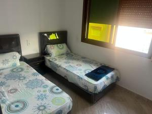 Postel nebo postele na pokoji v ubytování Apartamento familiar cerca del mar, Martil