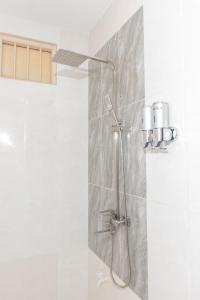 a shower in a bathroom with a shower head at Moro Fuvahmulah in Fuvahmulah +9 photos