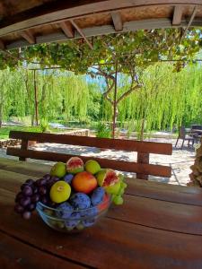 a bowl of fruit sitting on a wooden table at Kuća za odmor Buk in Čapljina