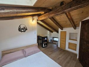 a bedroom with a white bed and wooden ceilings at Ai tre monti in Gorizia