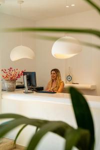 a woman sitting at a desk in an office at Nodo Boutique Hotel in Mýkonos City +72 photos